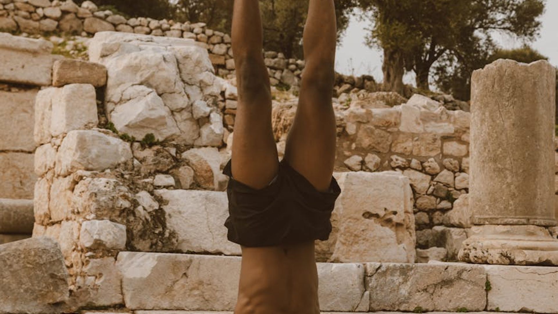 Man performing a controlled strength exercise in a calm setting.